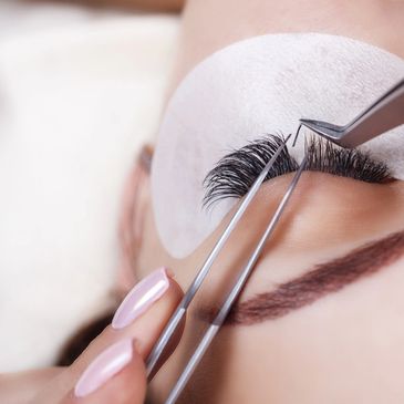 Technician carefully applying lash extensions